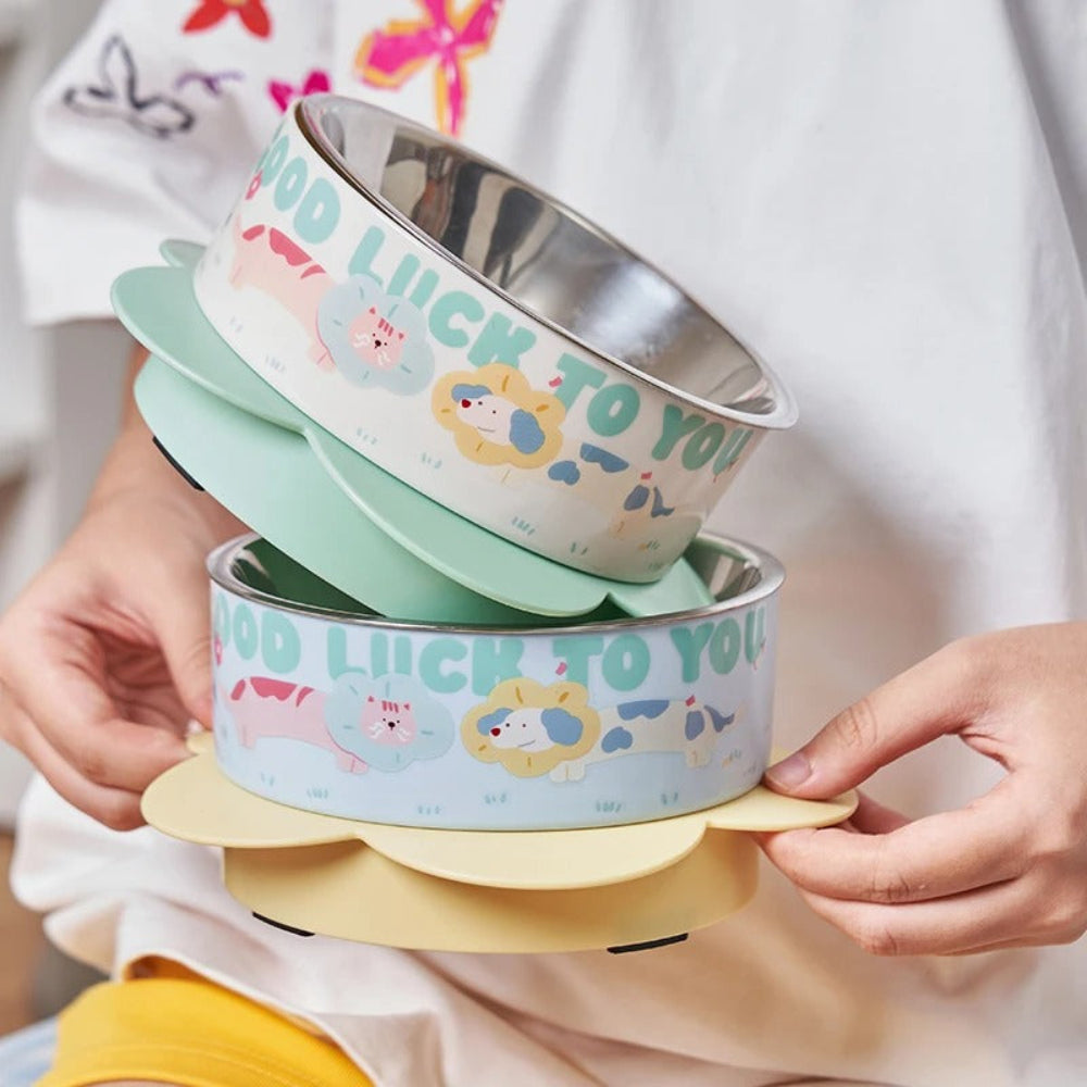 Stack of colorful bowls with cartoon designs held by a person