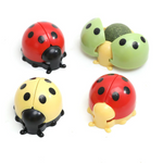 Set of four colorful ladybug-shaped objects on a white background