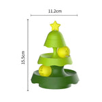 Green toy tree with yellow balls and a star on a white background