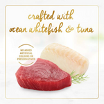 Two pieces of ocean whitefish and tuna with a dill sprig on a light background, labeled 'crafted with ocean whitefish & tuna' and 'no added artificial colours or preservatives'.
