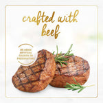 Two pieces of roasted beef with rosemary on a white background, labeled 'crafted with beef' and 'no added artificial colours or preservatives'.