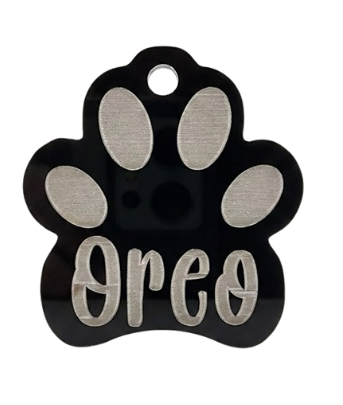 Paw-shaped pet tag with 'Oreo' engraved on a white background