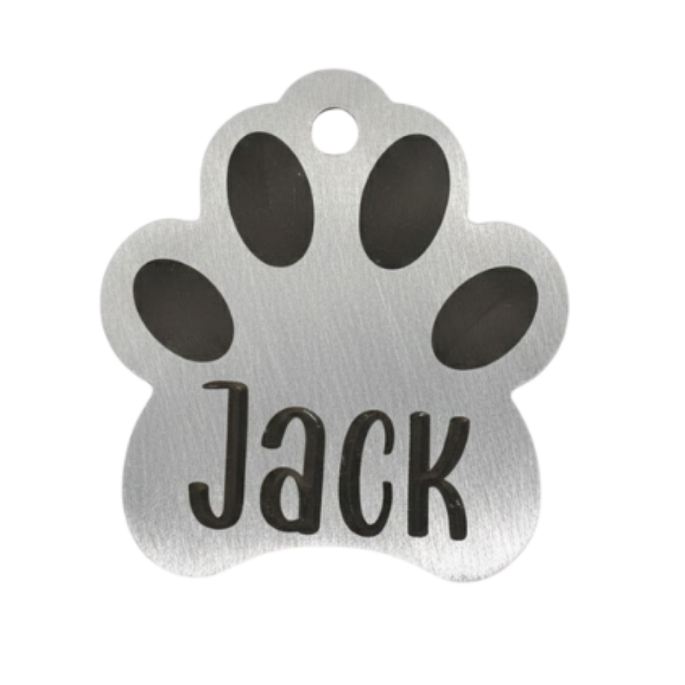 Silver paw-shaped pet tag with 'Jack' engraved on a white background