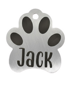 Silver paw-shaped pet tag with 'Jack' engraved on a white background