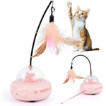 Cat toy with feather and transparent ball featuring a small pig figure, with a cat interacting with it.