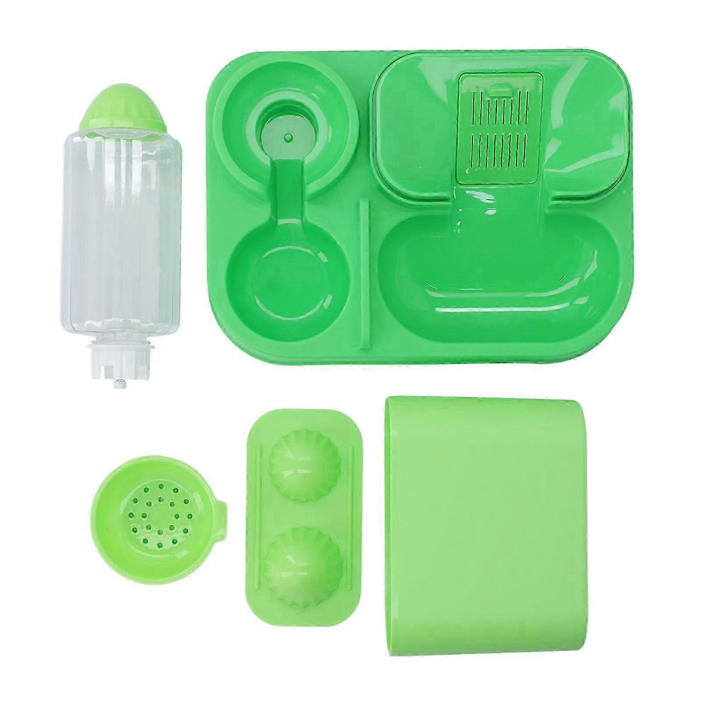 Set of green silicone kitchen tools on a white background