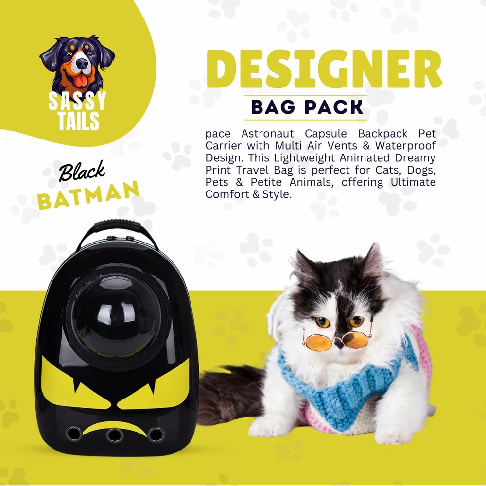 Pet carrier with Batman design and a cat wearing a scarf on a yellow background, featuring the brand 'Sassy Tails'.