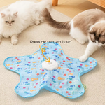 Cat playing with a colorful toy mat on a carpeted floor.