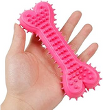 Pink heart-shaped textured tool held in a hand