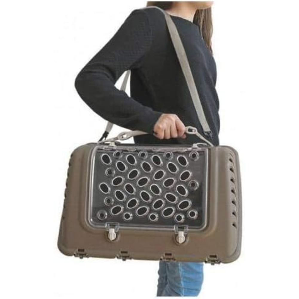 Person holding a pet carrier with a clear front panel