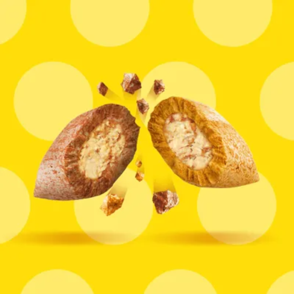 Split nutmeg with seeds on a yellow background