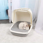 Cat inside a pet carrier on a light-colored floor with a blurred background