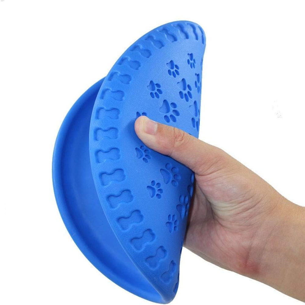 Blue silicone paw print impression tool held by a hand on a white background