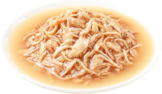 Plated dish of cooked noodles in a light broth on a white background