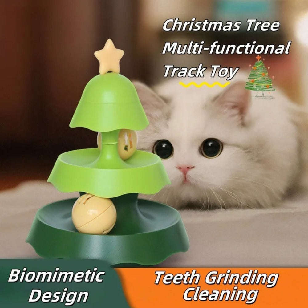 Cat playing with a green Christmas tree-shaped toy