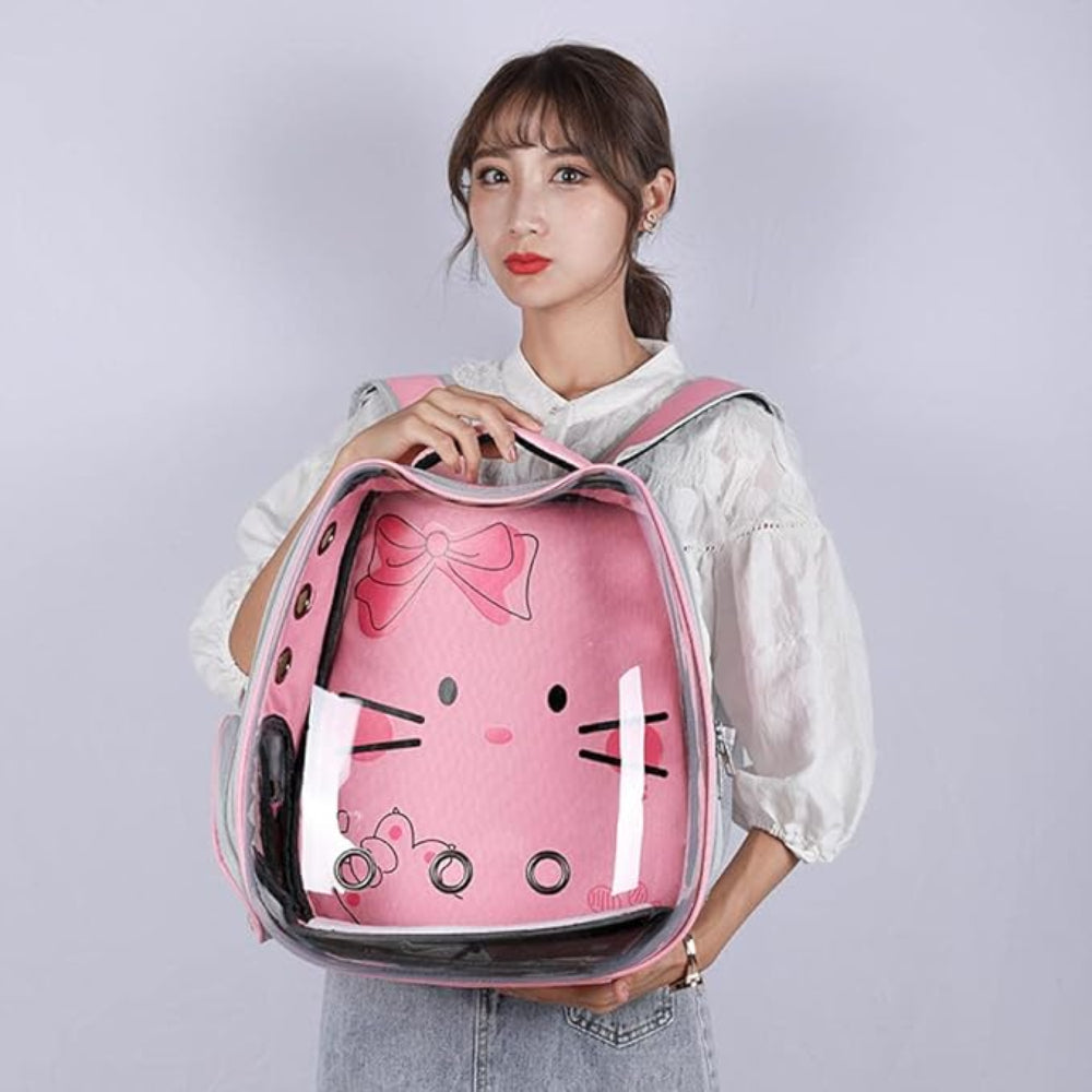 Person holding a pink cat-shaped backpack with a bow design on a plain background