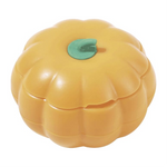 Yellow pumpkin-shaped container with a green leaf on a white background