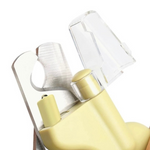 Close-up of a yellow and clear plastic tool on a white background