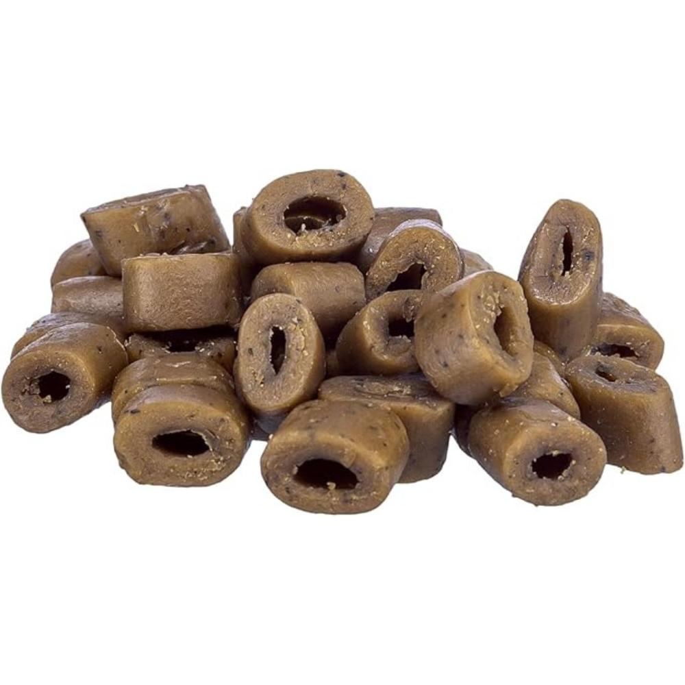 Brown cylindrical dog treats on a white background