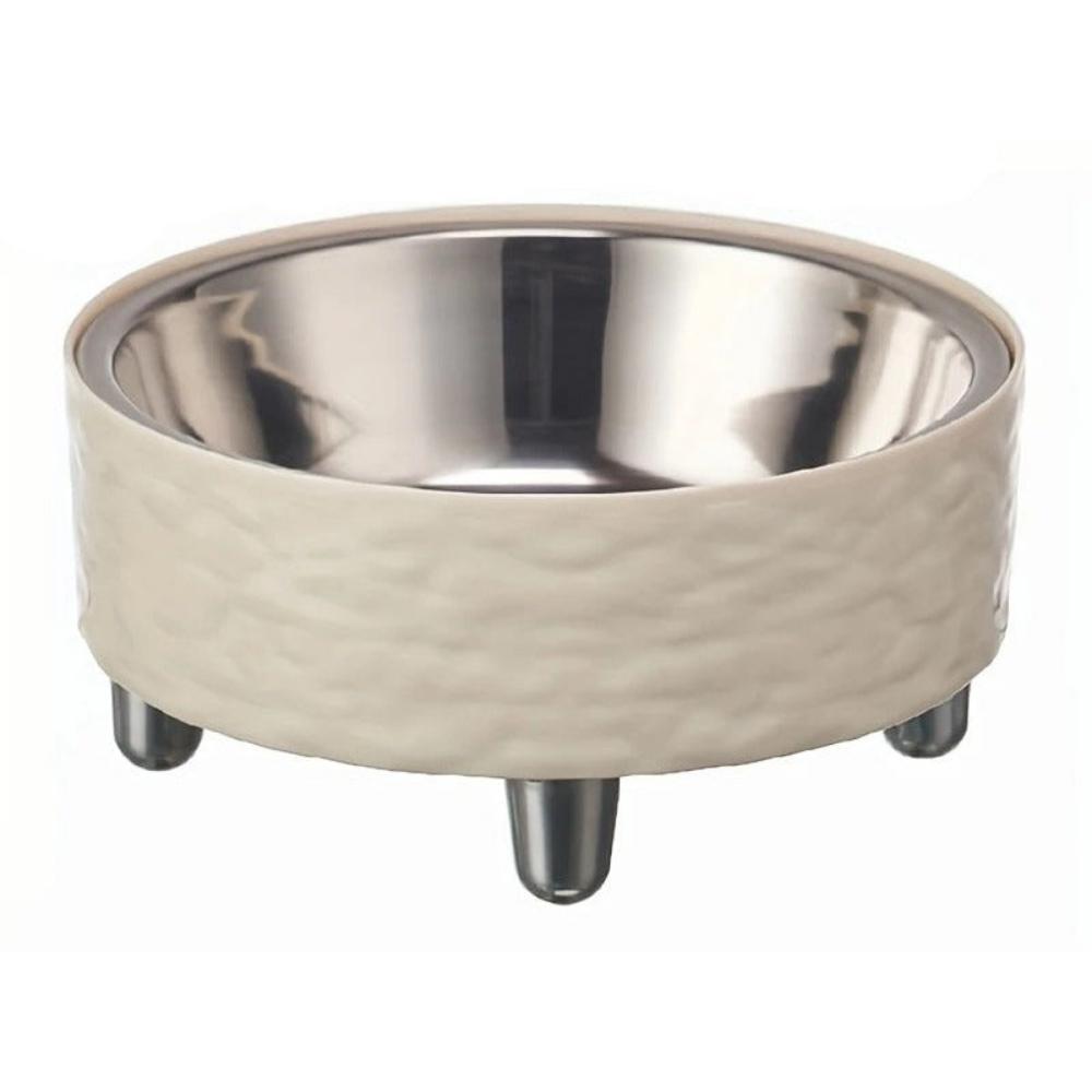 Stainless steel bowl with beige ceramic base on a white background