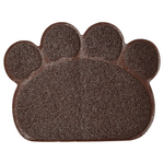 Brown doormat shaped like a paw print on a white background