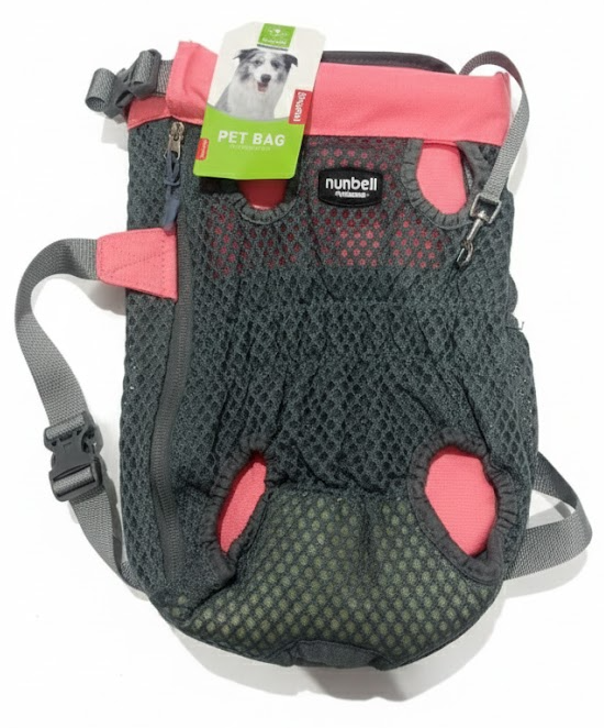 Pet carrier with pink accents and a visible brand tag on a white background