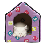 White cat inside a purple pet house with colorful paw and bone patterns on a white background