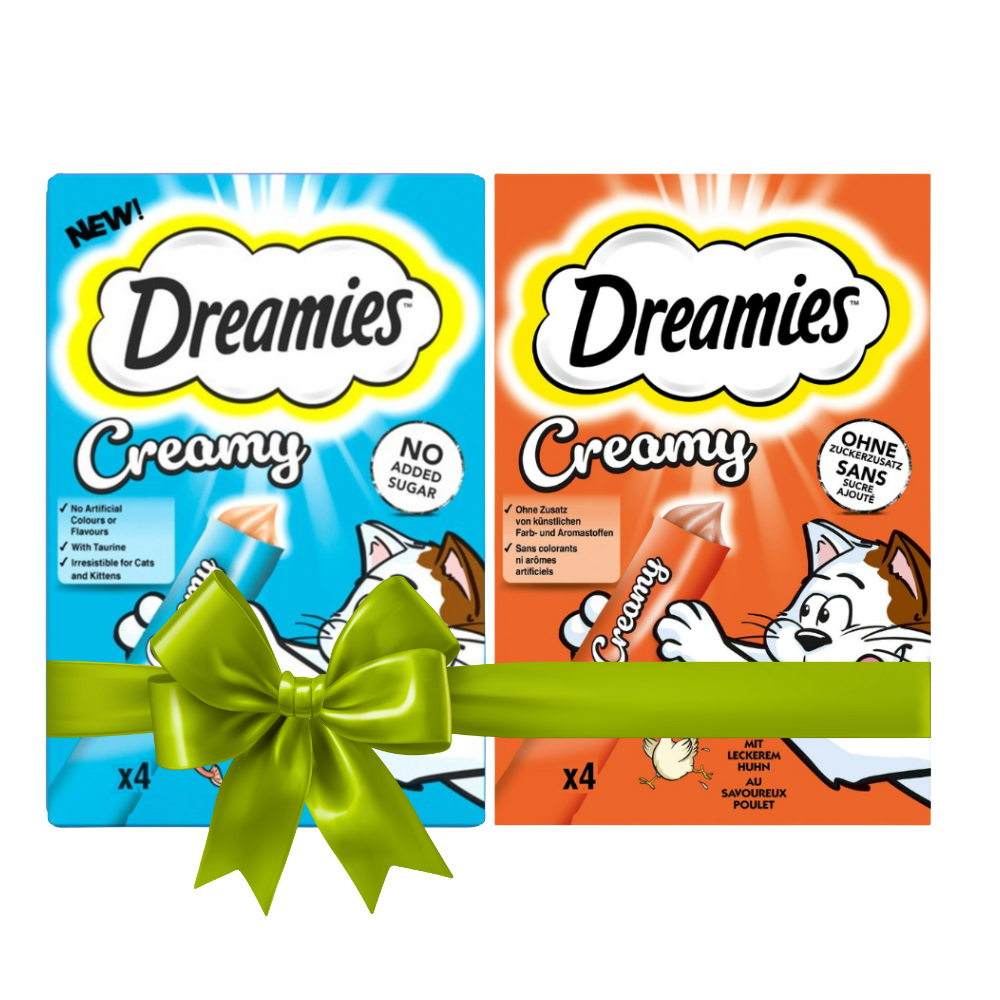 Two packages of Dreamies Creamy cat treats with a green bow on a white background