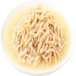 Noodles in a light broth on a white plate