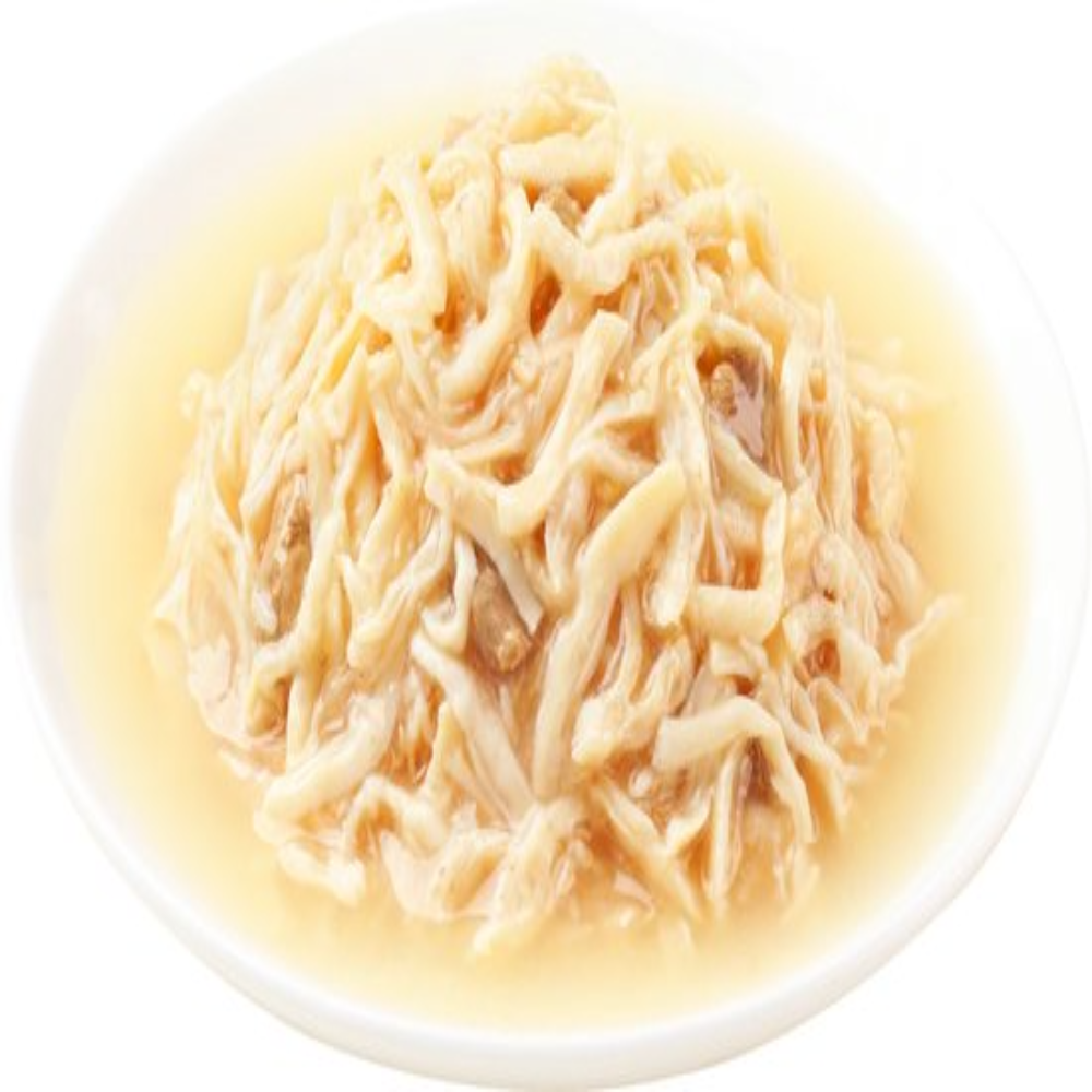 Noodles in a light broth on a white plate