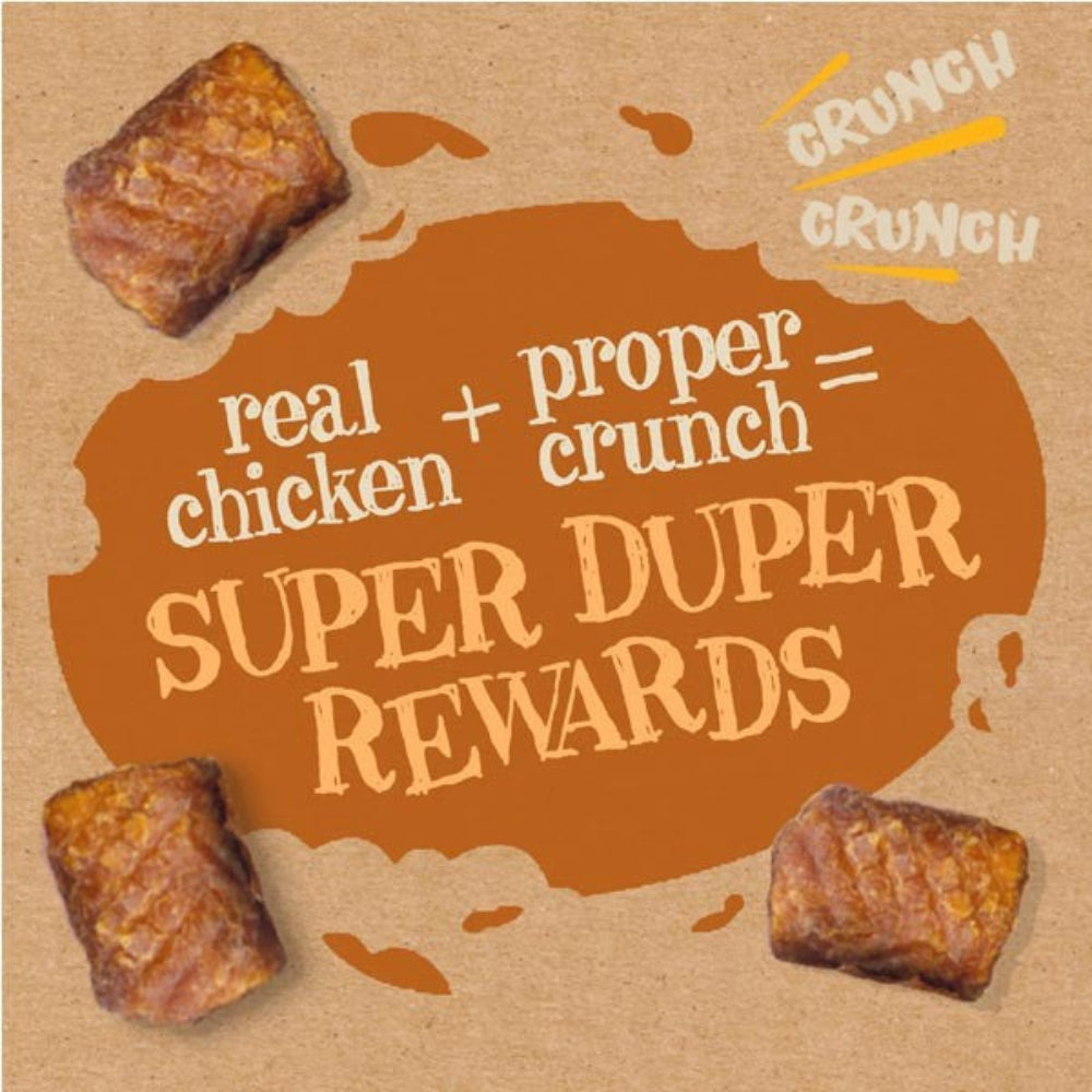 Promotional graphic for dog treats with text 'real chicken + proper crunch = super duper rewards' on a brown background.