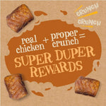 Promotional graphic for dog treats with text 'real chicken + proper crunch = super duper rewards' on a brown background.