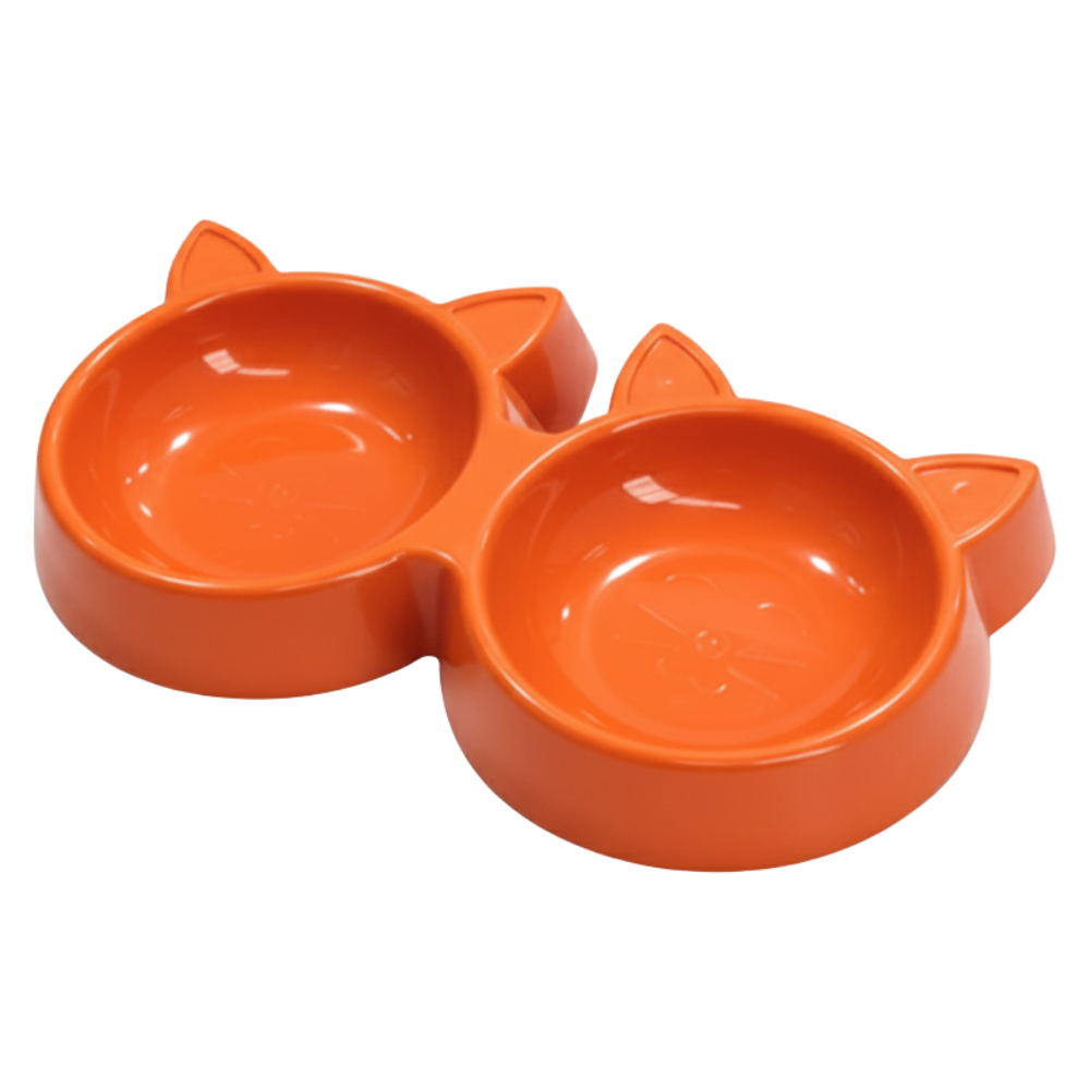 Orange pet bowl shaped like a cat's face on a white background