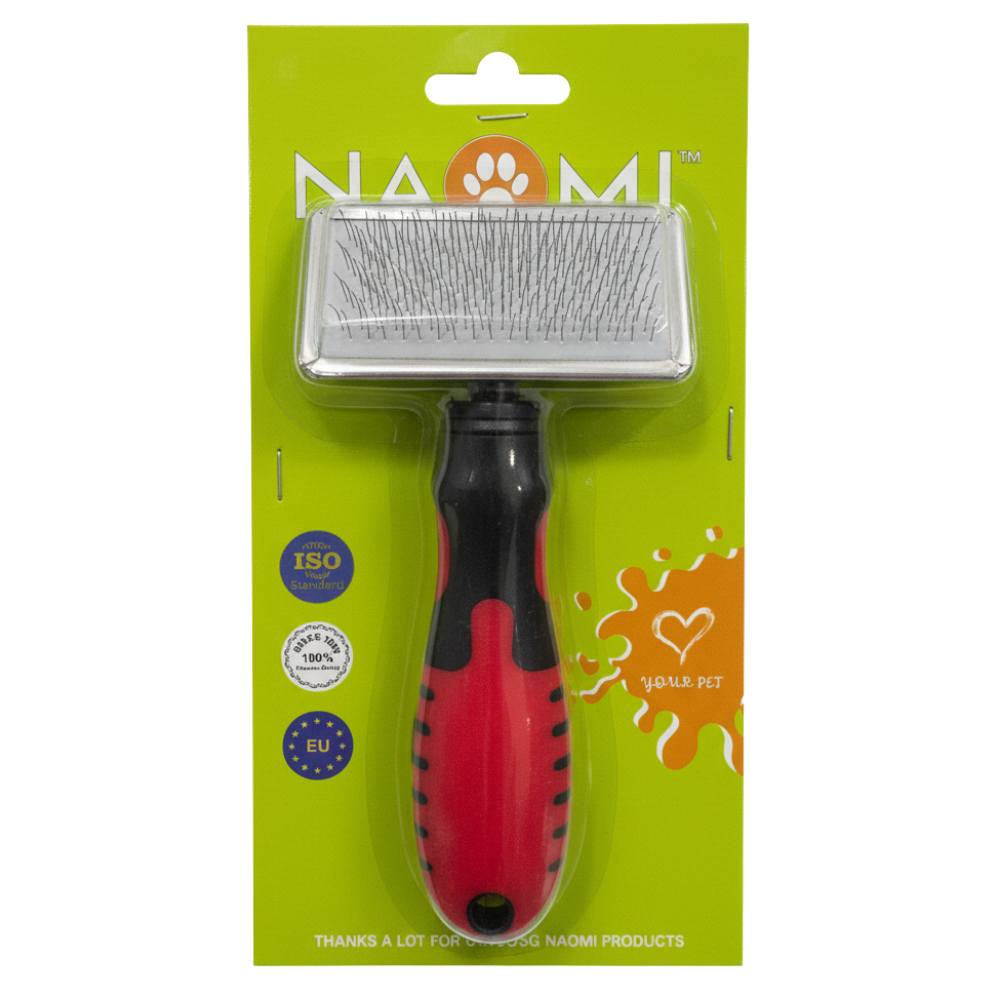 Pet grooming brush with red handle and black bristles on a green packaging background