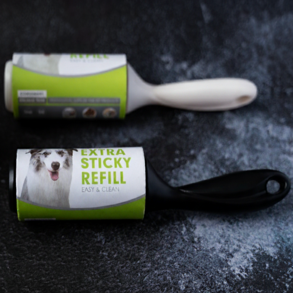 Lint roller with a visible brand label on a dark textured surface