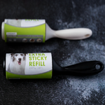 Lint roller with a visible brand label on a dark textured surface