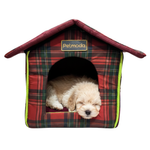 Plaid dog house with a puppy inside on a white background