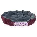 Round pet bed with floral patterned strip on a white background