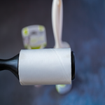 Roll of white paper with a black handle against a blurred background