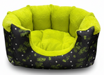Pet bed with green interior and black exterior with white patterns on a white background