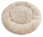 Round beige pet bed on a white background