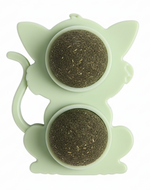 Green silicone tea infuser with two compartments on a white background