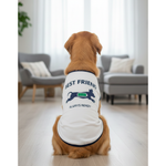 Dog wearing a white shirt with text in a living room setting