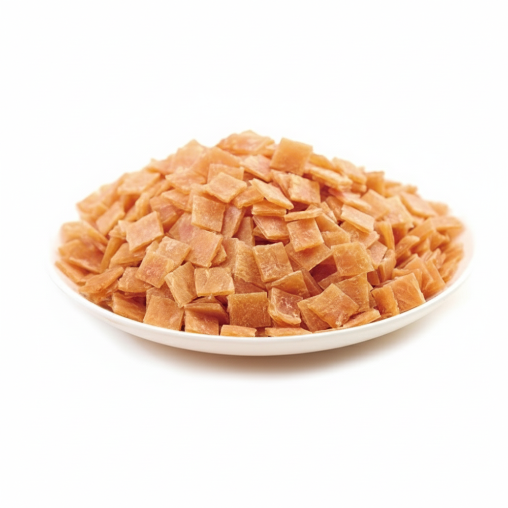 Diced dried apricots on a white plate with a white background