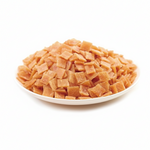 Diced dried apricots on a white plate with a white background