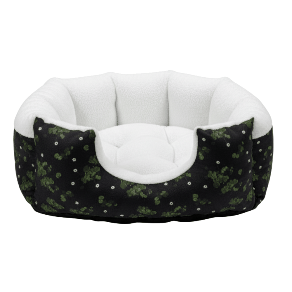 Pet bed with black and green pattern and white interior on a white background