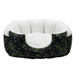 Pet bed with black and green pattern and white interior on a white background