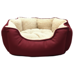Red pet bed with beige interior on a light gray background