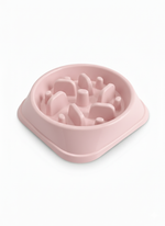 Pink dog food bowl with raised edges on a white background