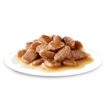 Plate of brown cat food on a white background